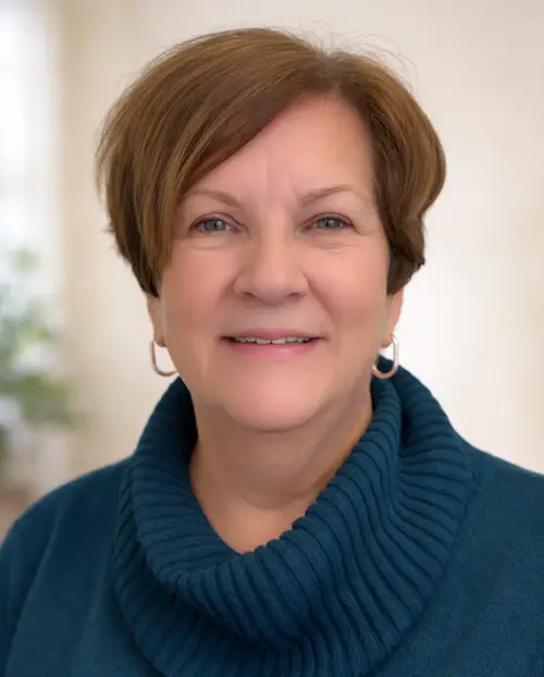 Portrait of a smiling woman in a blue sweater